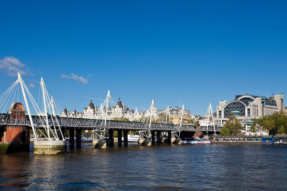 UK, London City, Hungerford Bridge and Golden Jubilee Bridges, Charing Cross Railway Station at background