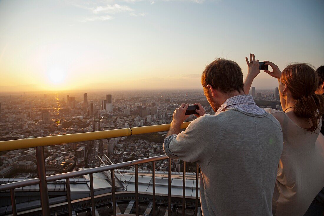 Japan,Tokyo,Roppongi,Tokyo City View Tower,Tourists Taking Photographs with Mobile Phones
