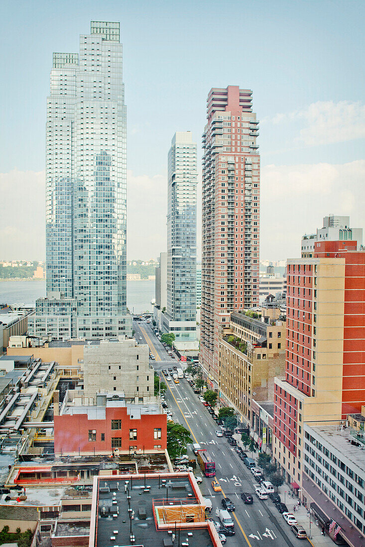 Skyscrapers in New York City with the Hudson River in background, New York. The Big Apple. Roads and rooftops. Buildings reflected in glass surfaces of skyscrapers.