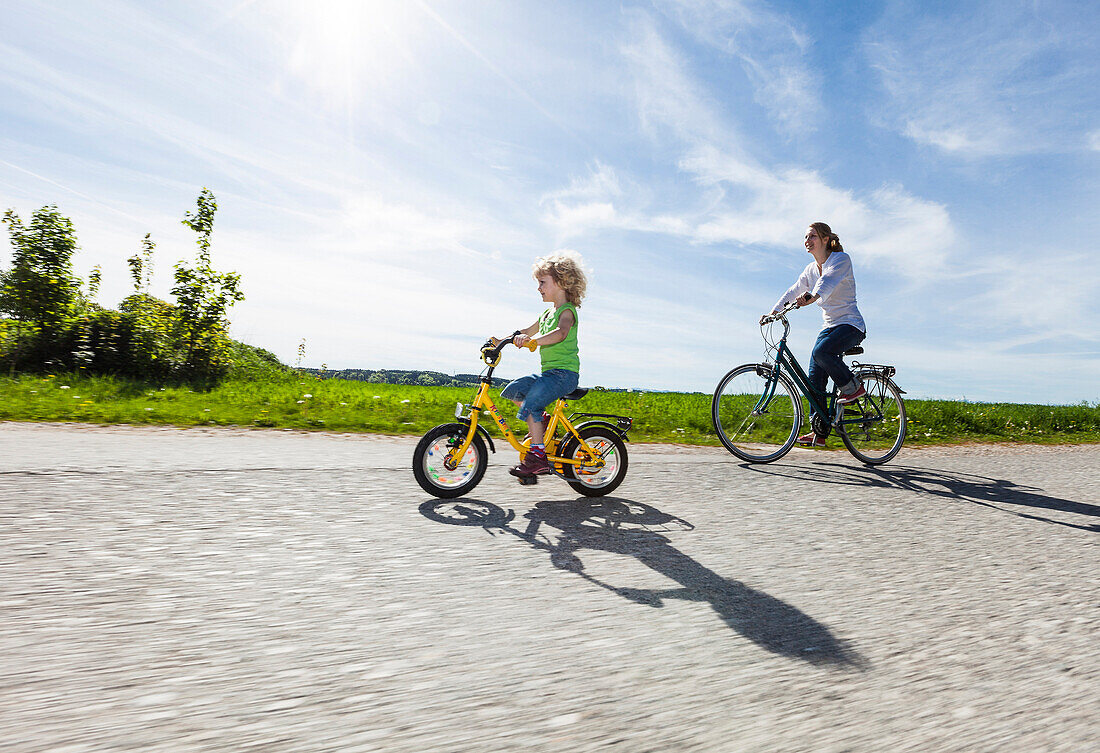 Mother and daughter bicycling, Upper Bavaria, Germany