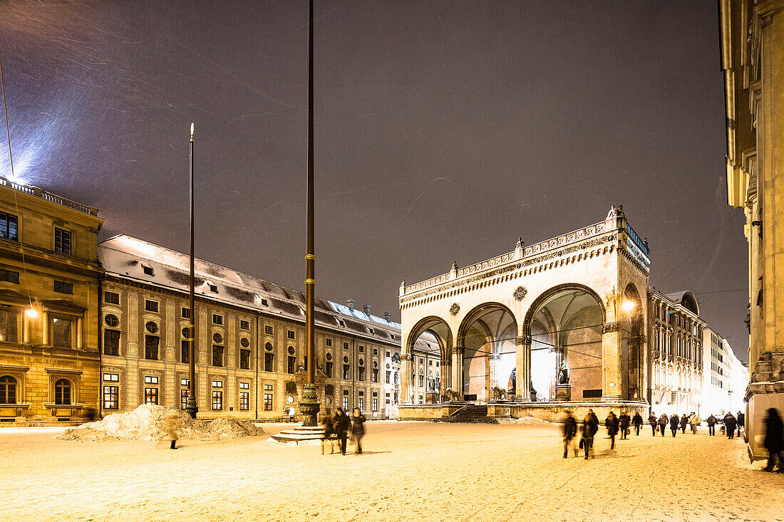 People at Odeonsplatz with Feldherrnhalle at night in winter, Munich, Upper Bavaria, Bavaria, Germany