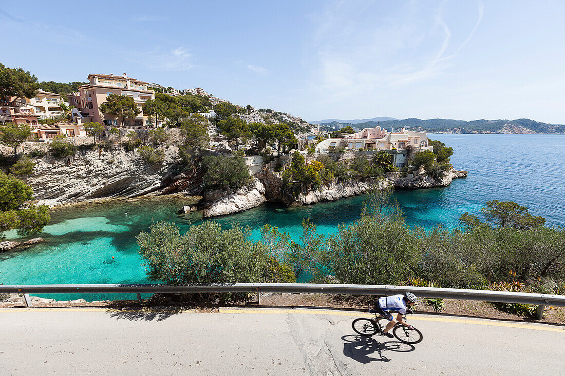 Bicycle rider at the Mediterranean coast, Peguera, Majorca, Balearic Islands, Spain