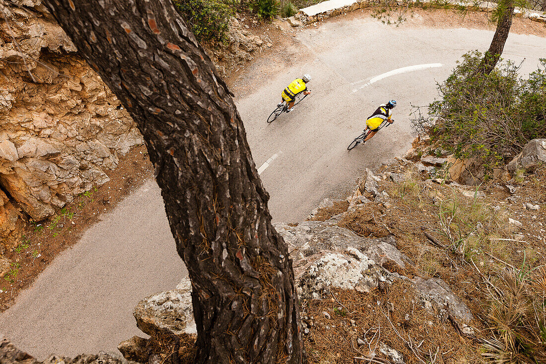 Bike racers on pass above Es Capdella, Mallorca, Spain