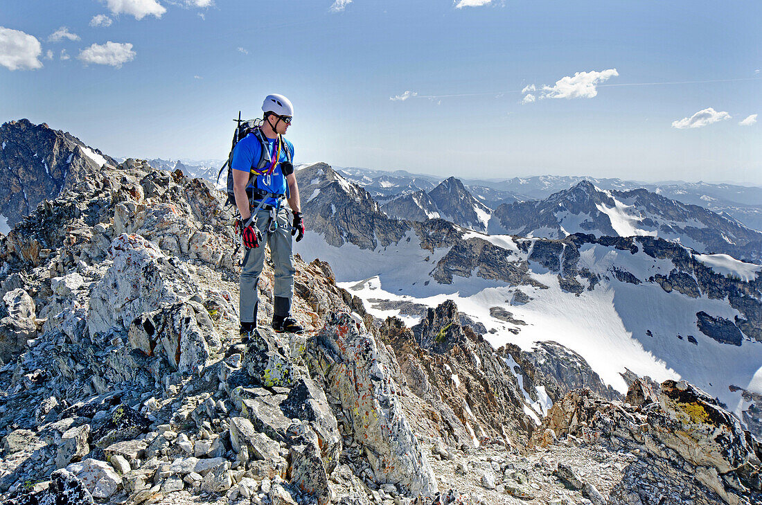 Elijah Weber on the summit after climbing The June Couloir on the North Face of Williams Peak high above the Sawtooth Valley in the Sawtooth Mountains near the town of Stanley in central Idaho