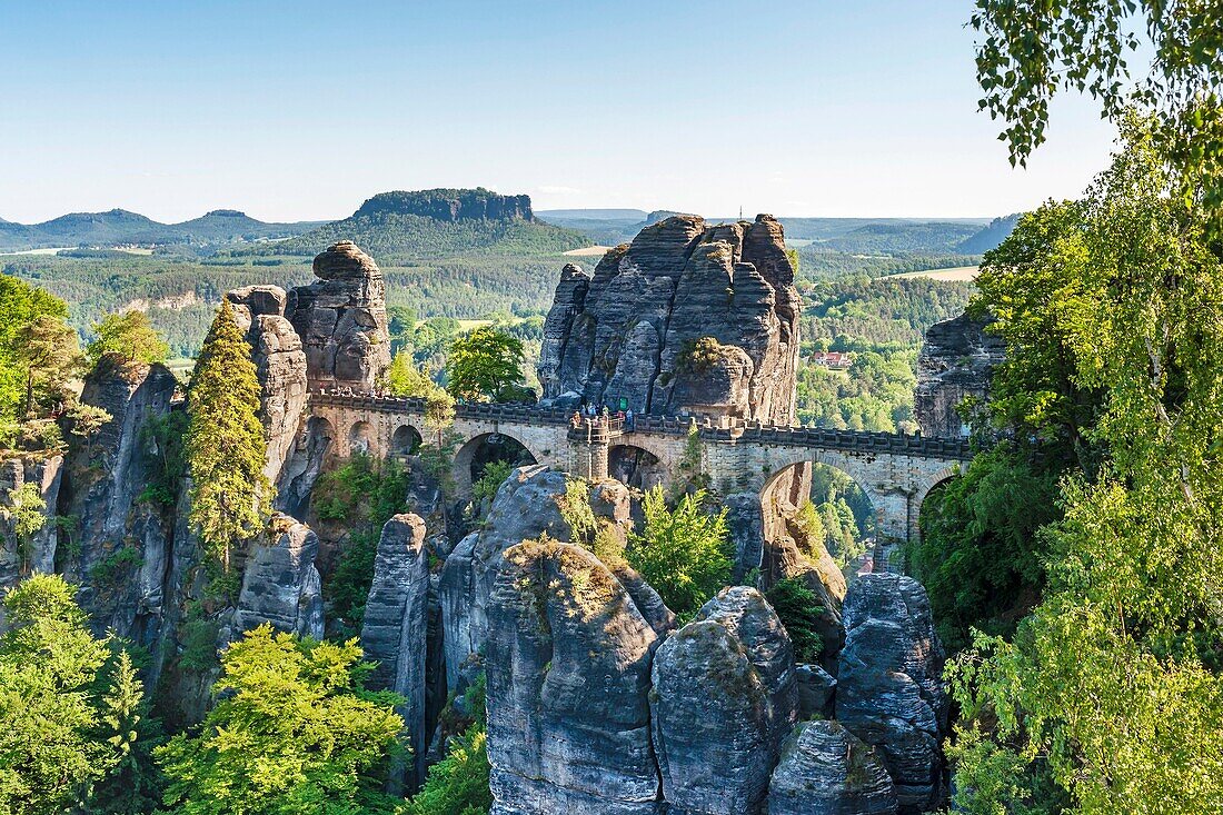 View from Ferdinand stone to the spectacular rock formation Bastei Bastion and Bastei Bridge It is one of the most visited tourist attractions in the Saxon Switzerland Behind it is the Table Mountain Lilienstein He is one of the most striking mountains in