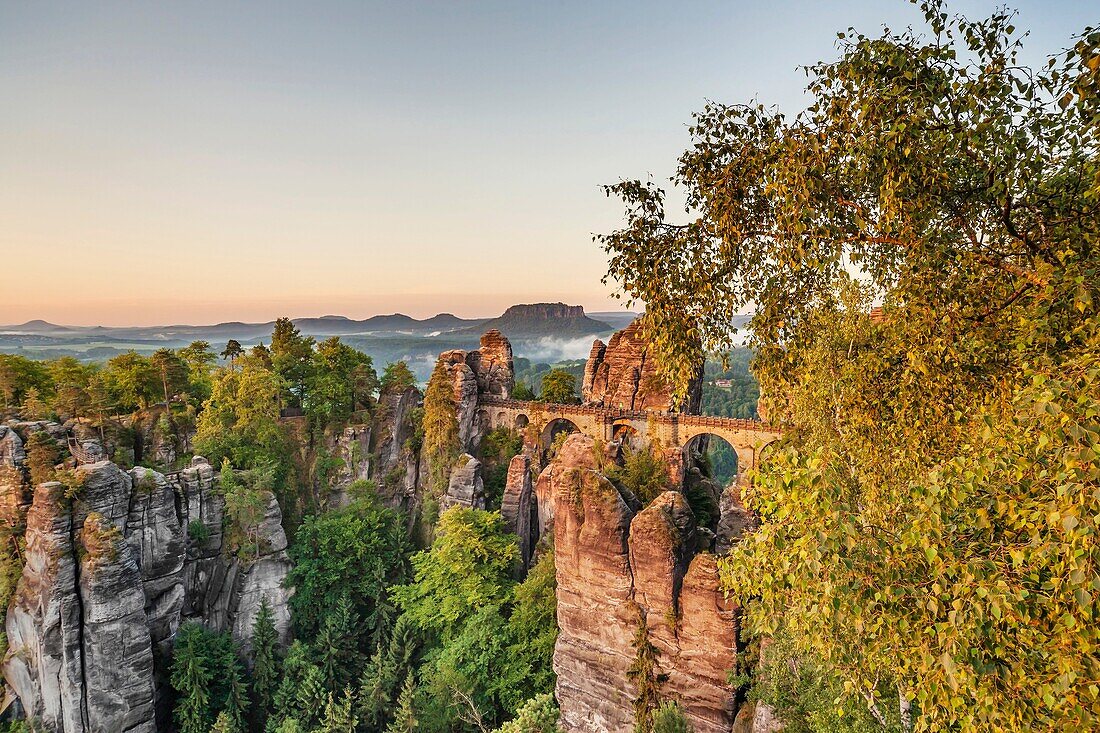View from Ferdinand stone to the spectacular rock formation Bastei Bastion and Bastei Bridge It is one of the most visited tourist attractions in the Saxon Switzerland Behind it is the Table Mountain Lilienstein He is one of the most striking mountains in