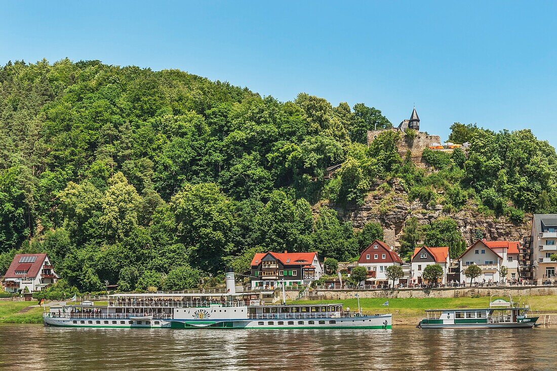 View over the Elbe river to the health resort Rathen Lower Rathen and the castle Altrathen The castle is first mentioned 1289 The paddle steamer Leipzig is on the Elbe river The steamship was built in 1929 and is the largest paddle steamer of the fleet of
