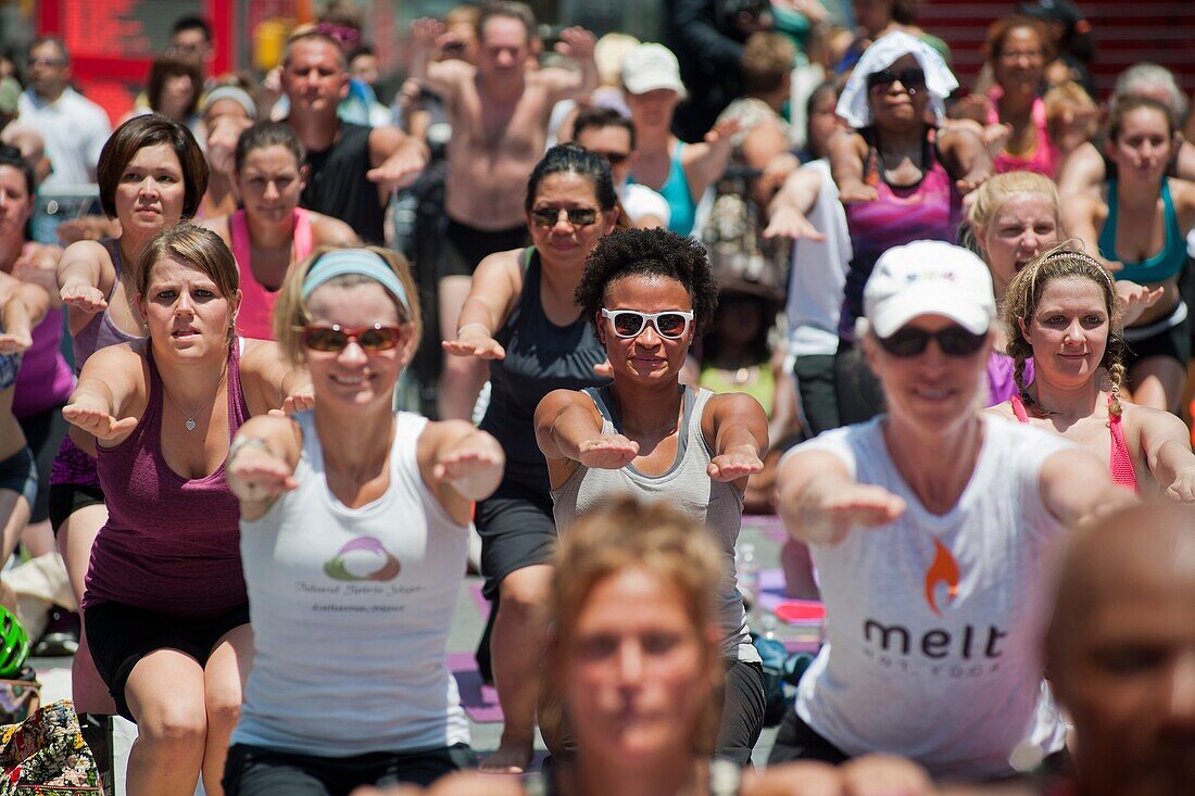 Thousands of yoga practitioners in Times Square in New York participate in a mid-day Bikram Yoga class on the first day of summer Temperatures are expected to rise into the upper 90´s today as most New Yorkers seek relief from the heat