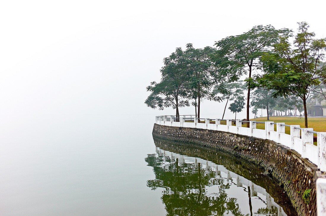 The barrier wall on a desolate and foggy West Lake in Hanoi, Vietnam