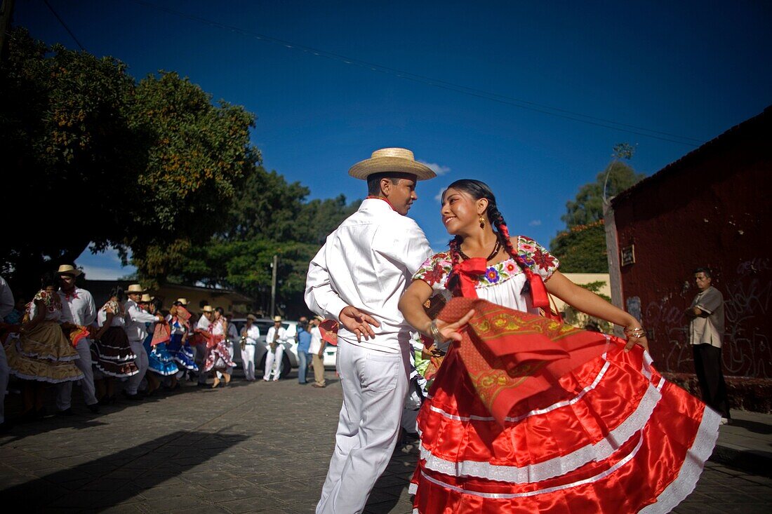 A young couple wearing traditional dresses dance during the Guelaguetza parade in Oaxaca, Mexico, July 21, 2012  Oaxaca commemorates the ´Guelaguetza,´ an annual celebration by all seven of the state´s regions, as they converge on the capital to demonstra