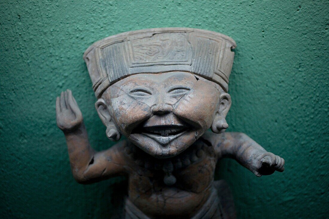 Sculpture of a smiling boy displayed at the Rufino Tamayo pre-Hispanic art museum in Oaxaca, Mexico