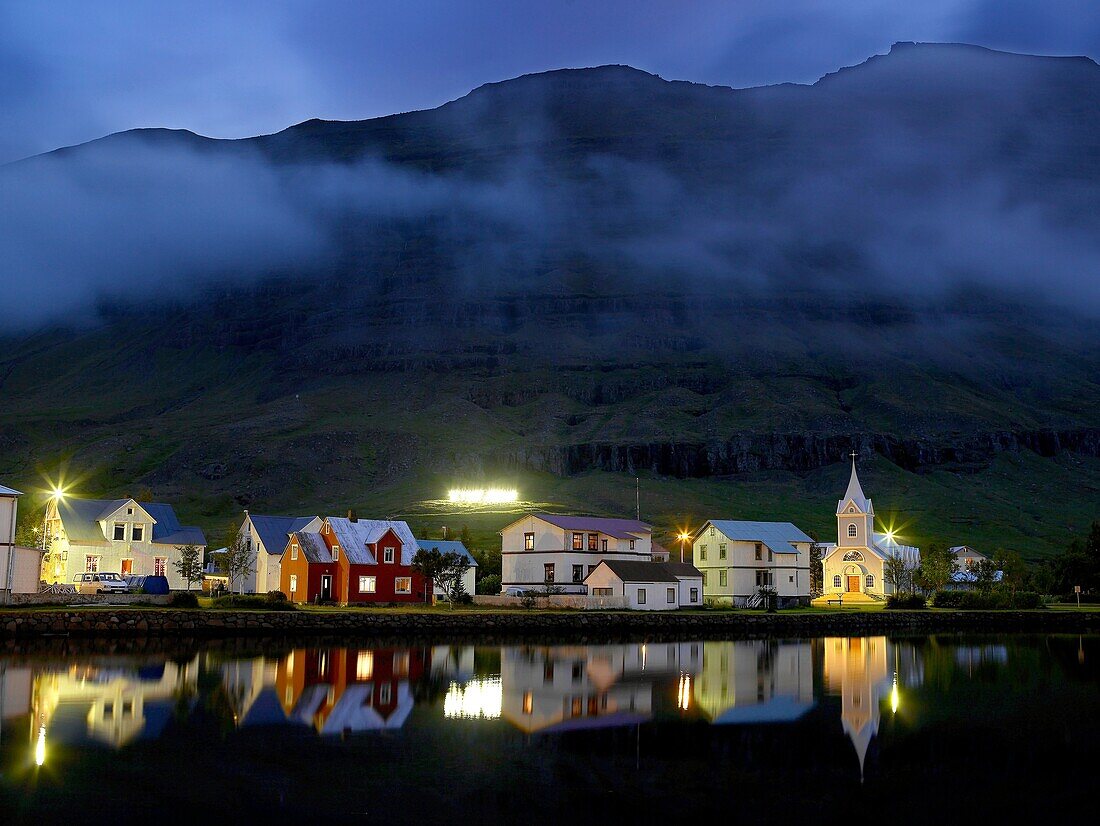 Homes reflecting in fjord, Seydisfjordur, Iceland