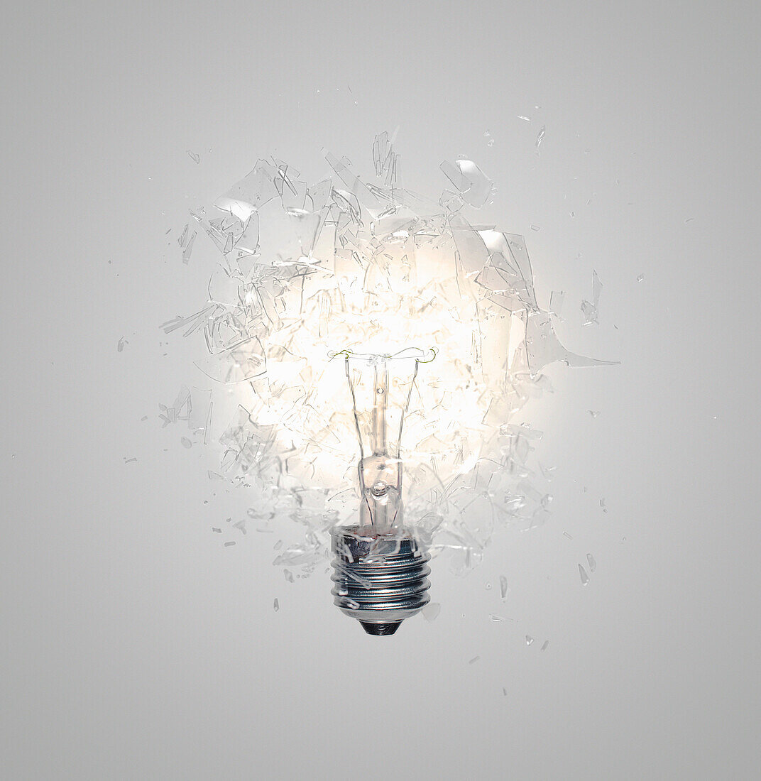 A Light Bulb shattering, exploding. Close up of light bulb shattering