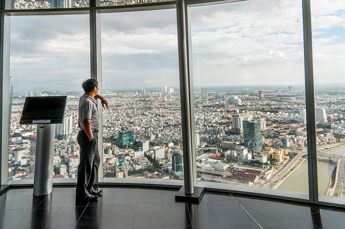 Young man looking towards the city of Saigon, south Vietnam, Vietnam, Asia