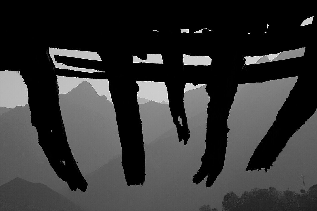 Mountains Viewed From Underneath Silhouette of Old Wood Roof