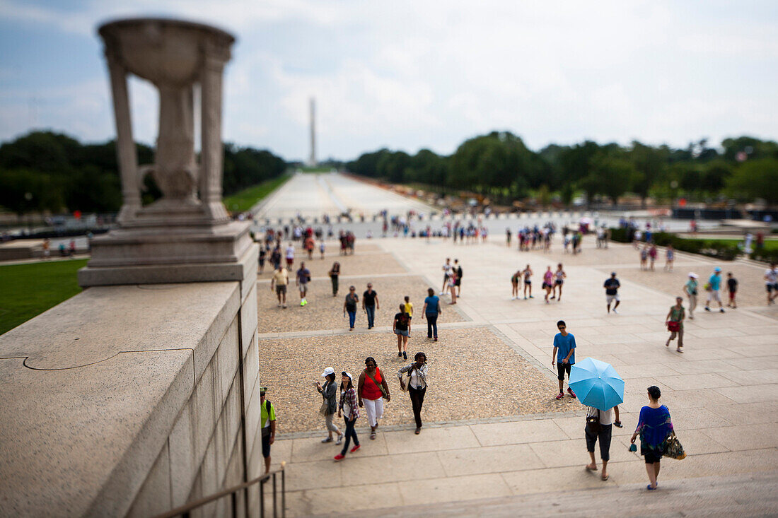 Tourists on Steps of Lincoln Memorial with View to Reflecting Pond and Washington Monument, Washington, DC, USA