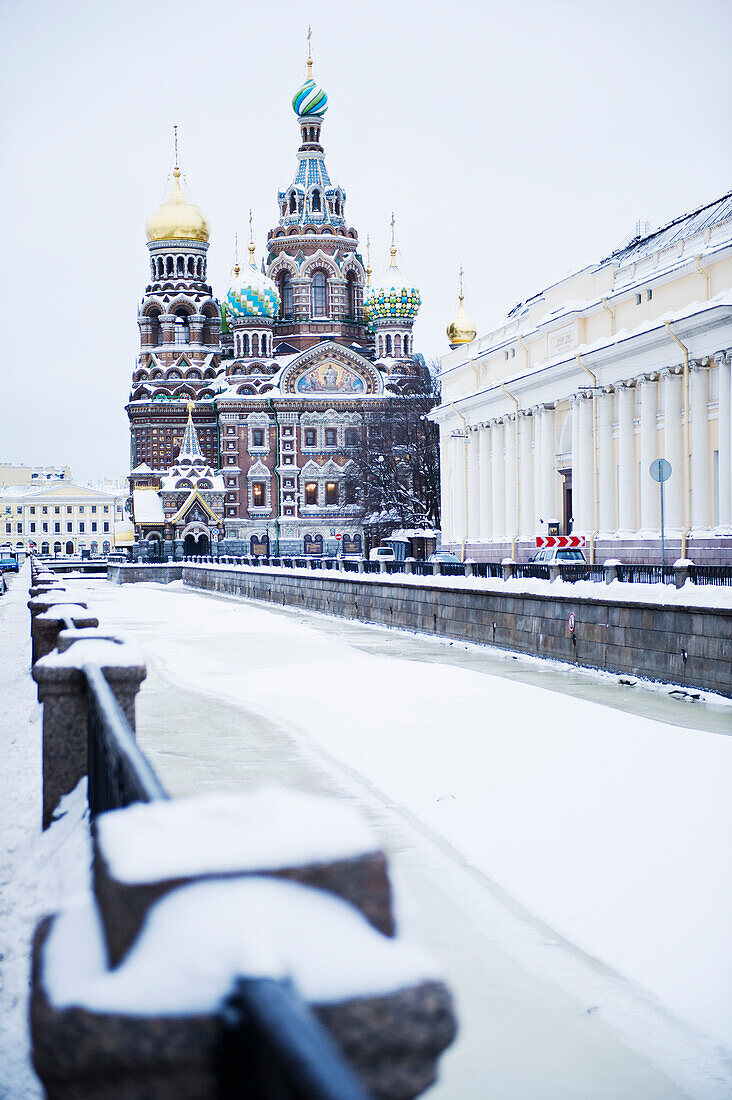 the Church of the Savior on Spilled Blood, a traditional Russian Orthodox church built in 1907, on the The Griboedov Canal. Winter. Snow.