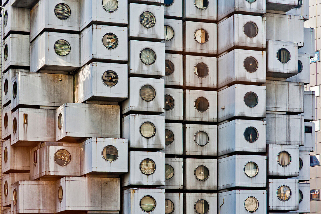 The Akagin Capsule Tower in Ginza, a famous Japanese Metabolist concrete building by Kisho Kurokawa. Modern architecture.