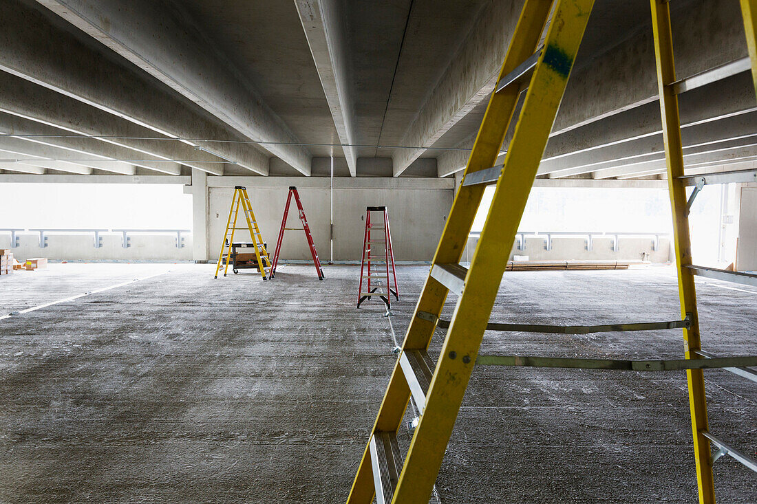 A construction site, the building of a parking garage, A concrete construction, Car park, Ladders