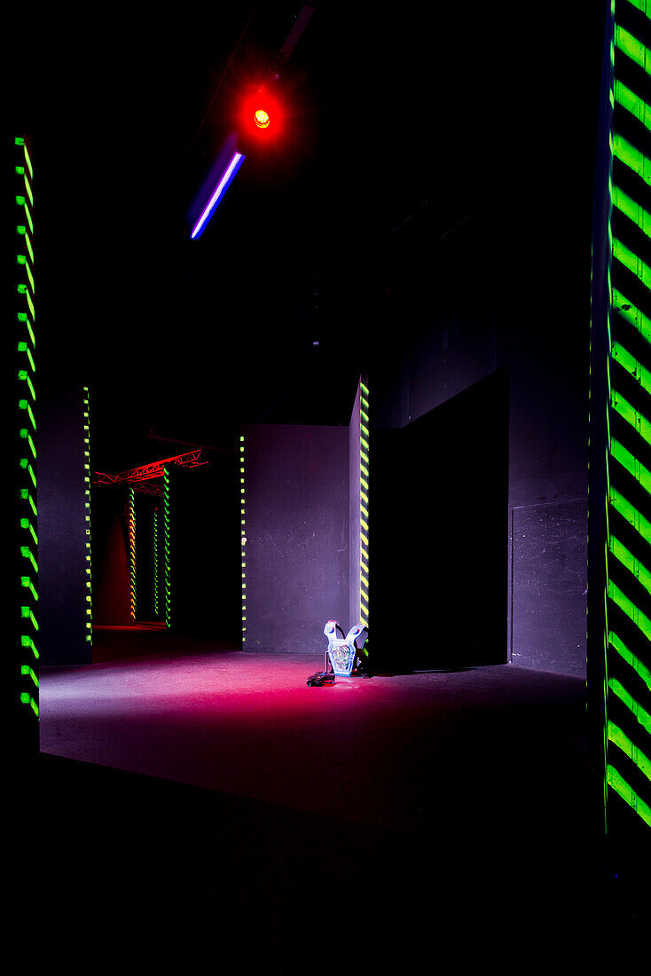 Laser game playing space with narrow corridors and walls, A gaming room with a suit of body armour and a weapon