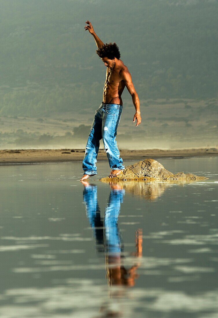 Man Walking Along Seashore