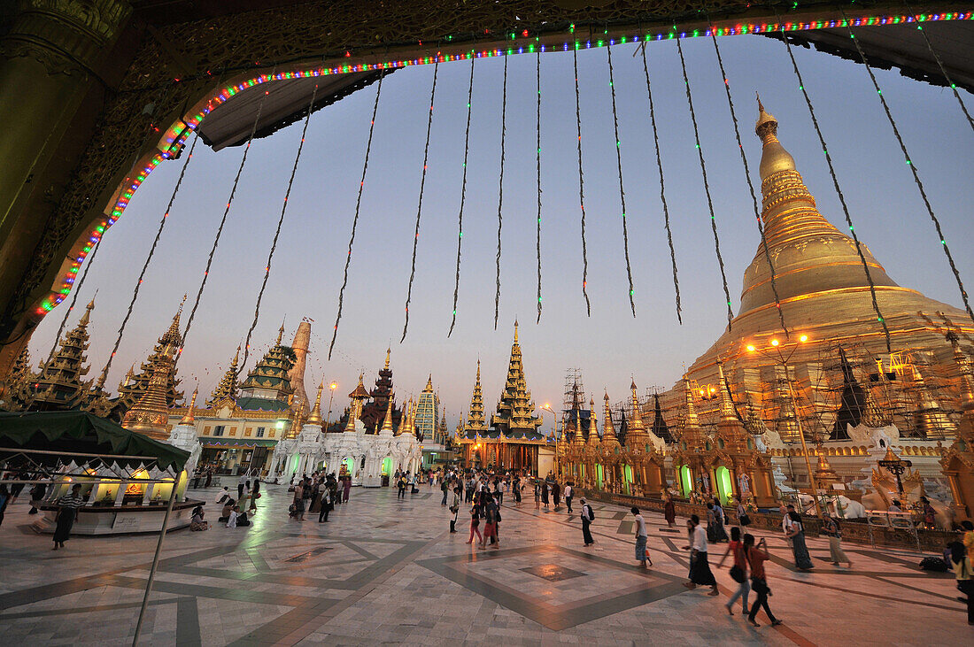 Viw of the Shwedagon Pagoda with people on the square, Yangon, Myanmar, Burma, Asia