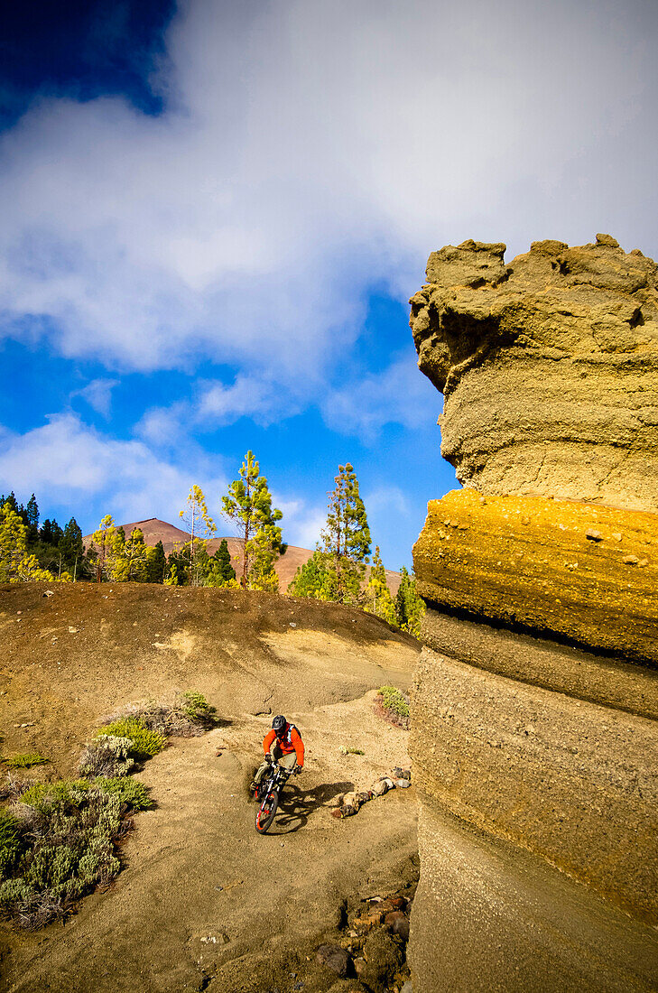 Downhill mountain biker on a trail in the mountains, Tenerife