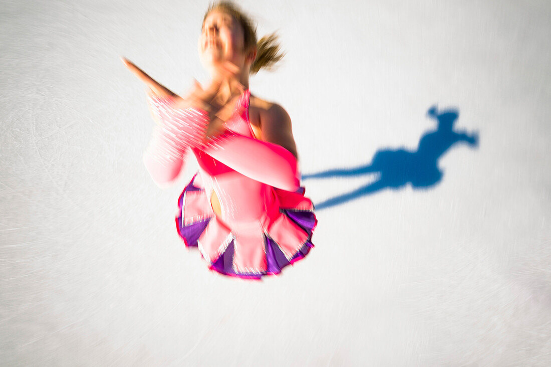 Ice figure skater performing on ice rink