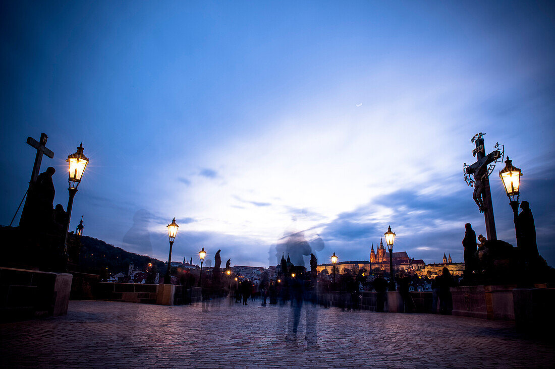 Charles bridge at dusk with view of the old town of Prague, Prague, Czech Republic