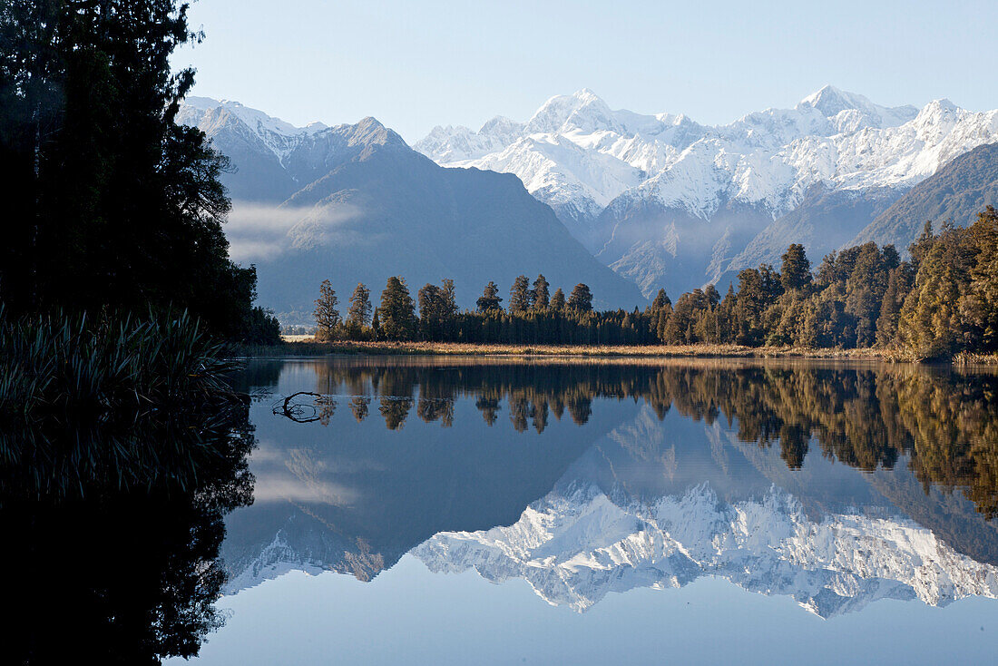 blocked for illustrated books in Germany, Austria, Switzerland: Perfect mountain reflection in Lake Matheson with Mount Tasman and Mount Cook, Aoraki, Southern Alps, West Coast, South Island, New Zealand