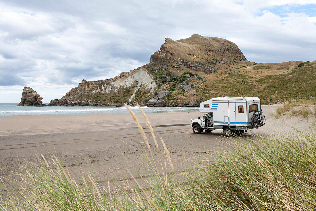 Camper van parked on the beach at Castle Point, Wellington Region, North Island, New Zealand