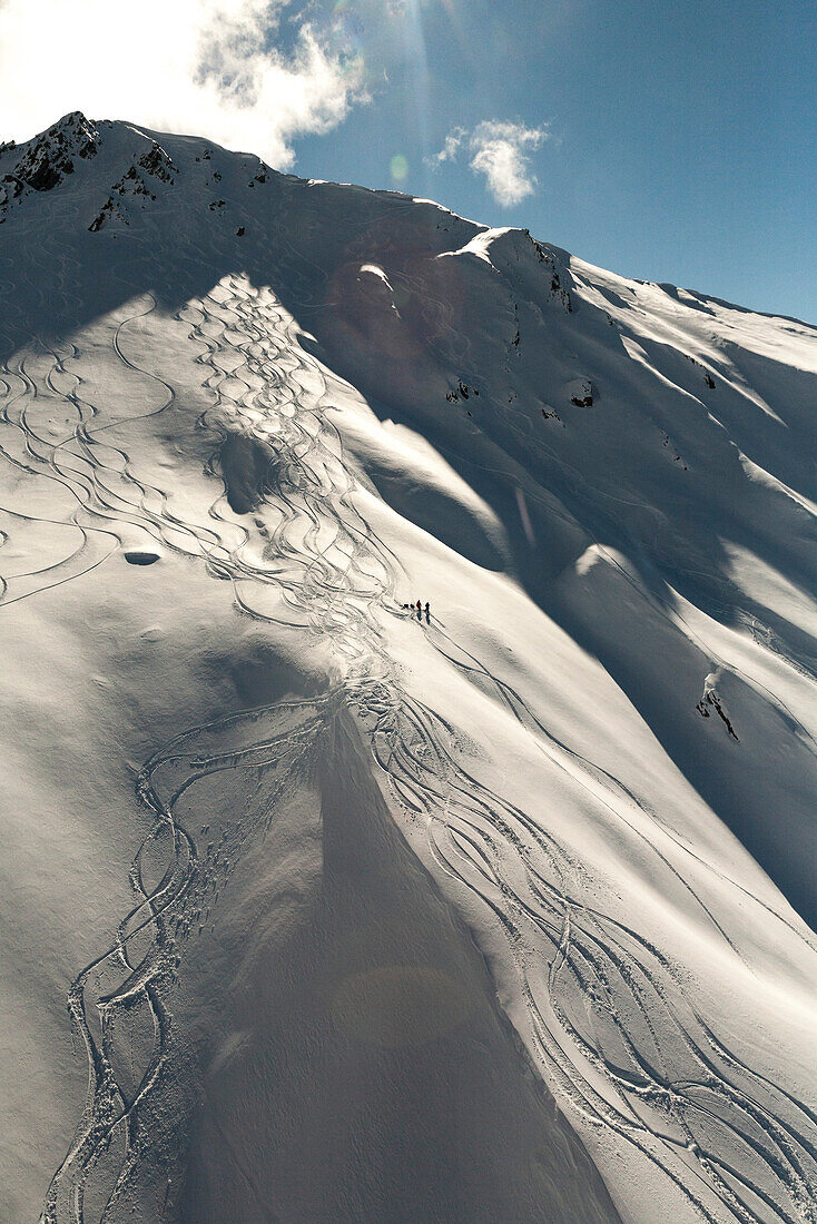Aerial of snowboarders on a mountain slope, South Island, New Zealand