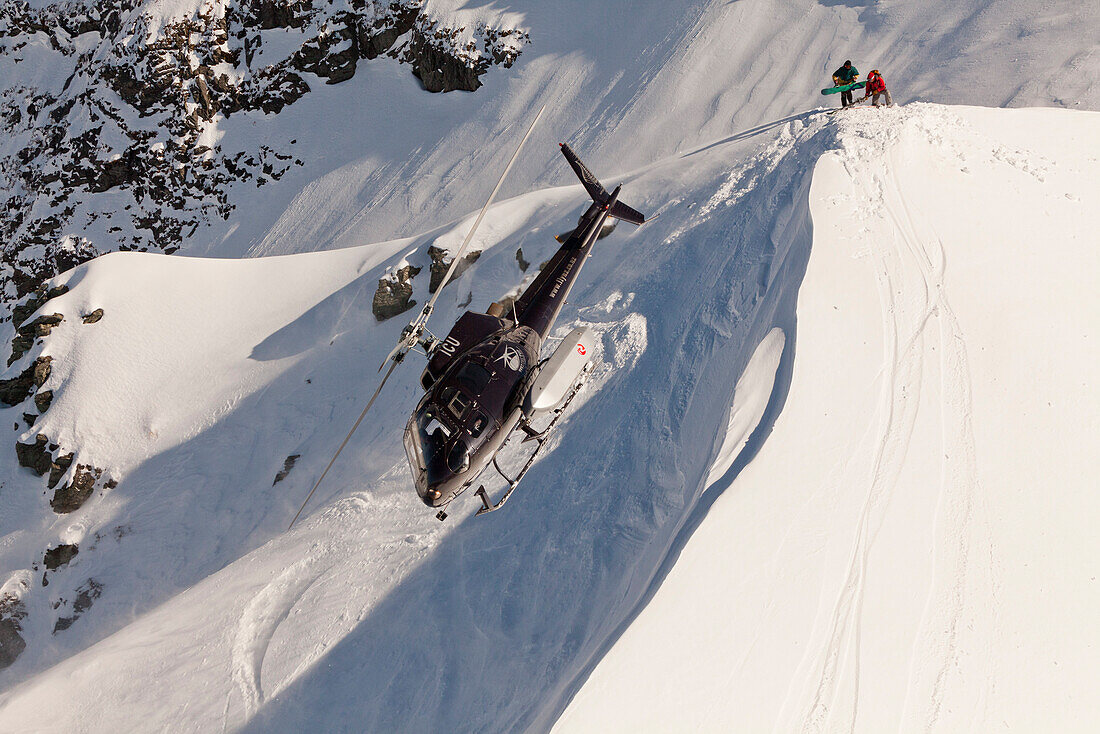 Helicopter landing with winter sportsmen, Skiers and snowboarder, South Island, New Zealand