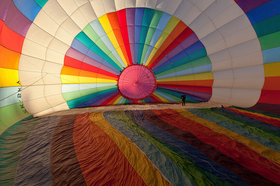 Brightly coloured hot air balloon from the inside, about to be filled with air before take-off, Sport