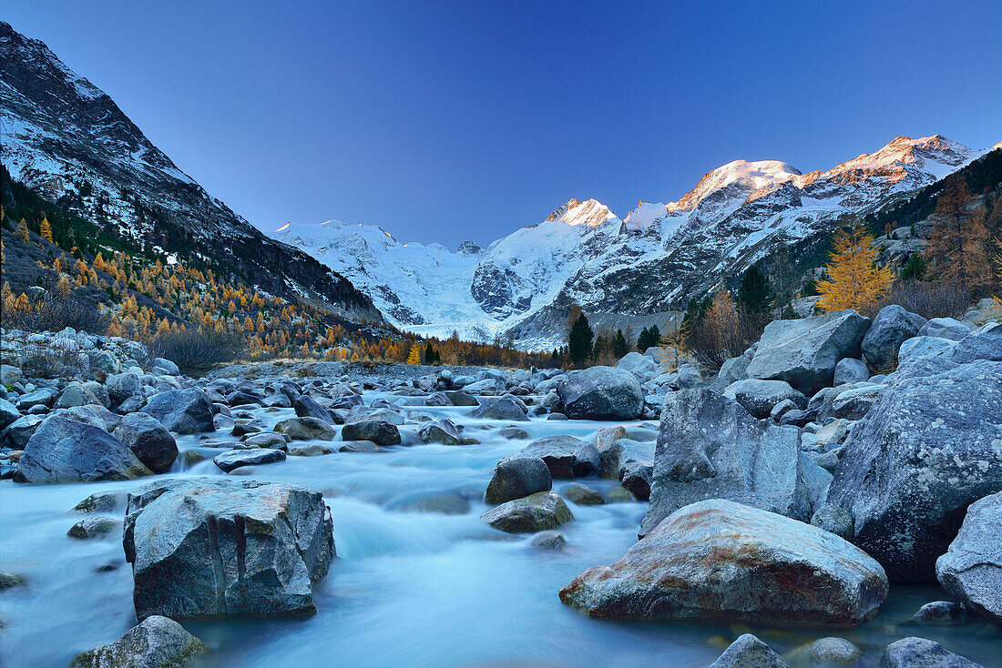 River flowing through Morteratsch valley in the morning light with Bernina range in the background, Bernina range, Engadin, Grisons, Switzerland