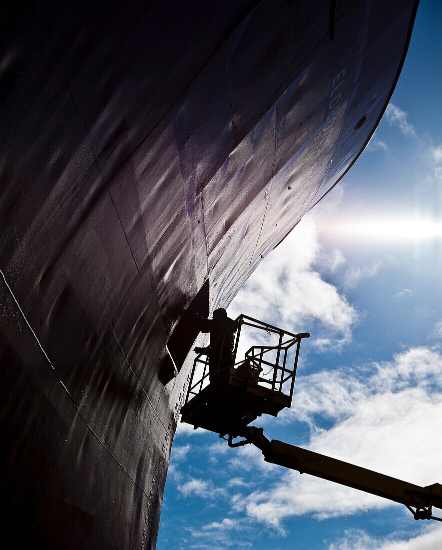 Painting fishing trawler at shipyard, Reykjavik, Iceland