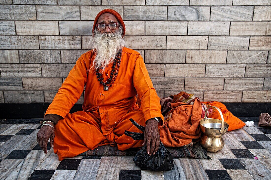 Sadhu wearing orange clothes sitting in a temple  Jodhpur, Rajasthan, India