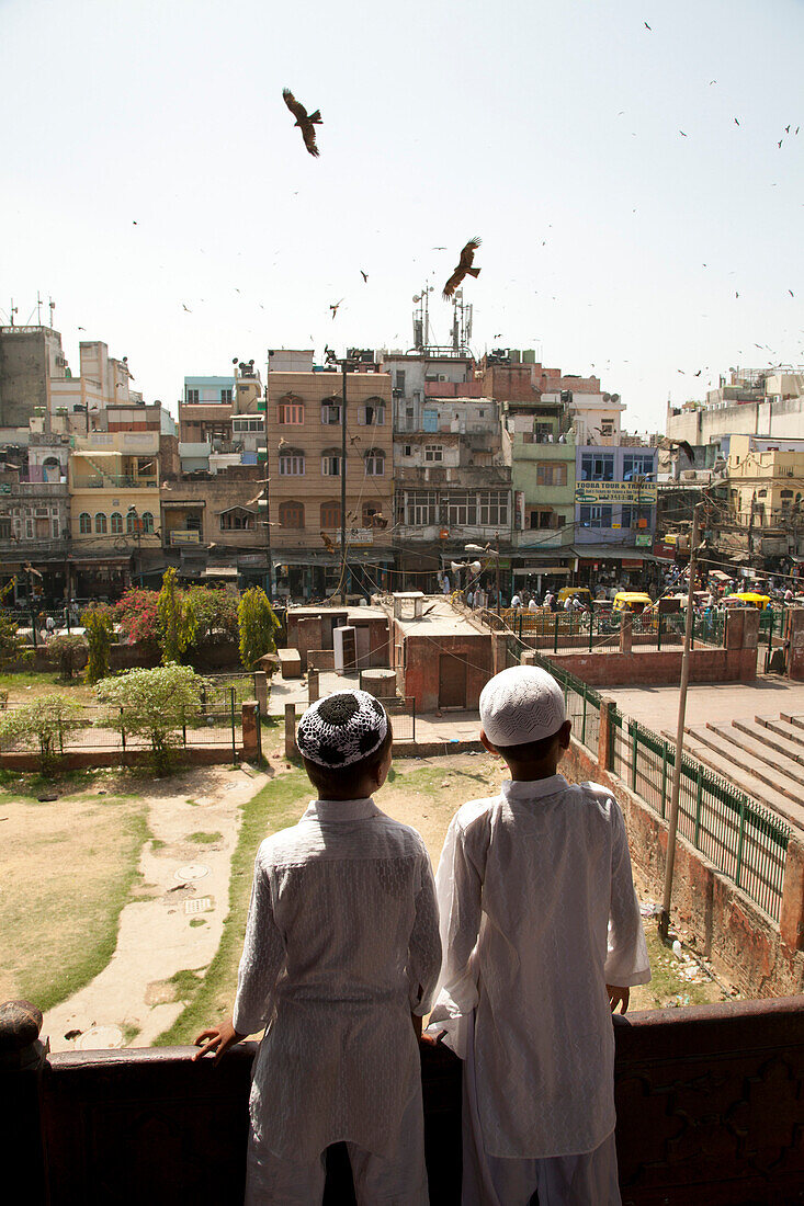Two Boys Looking at Urban Landscape, Old Delhi, India