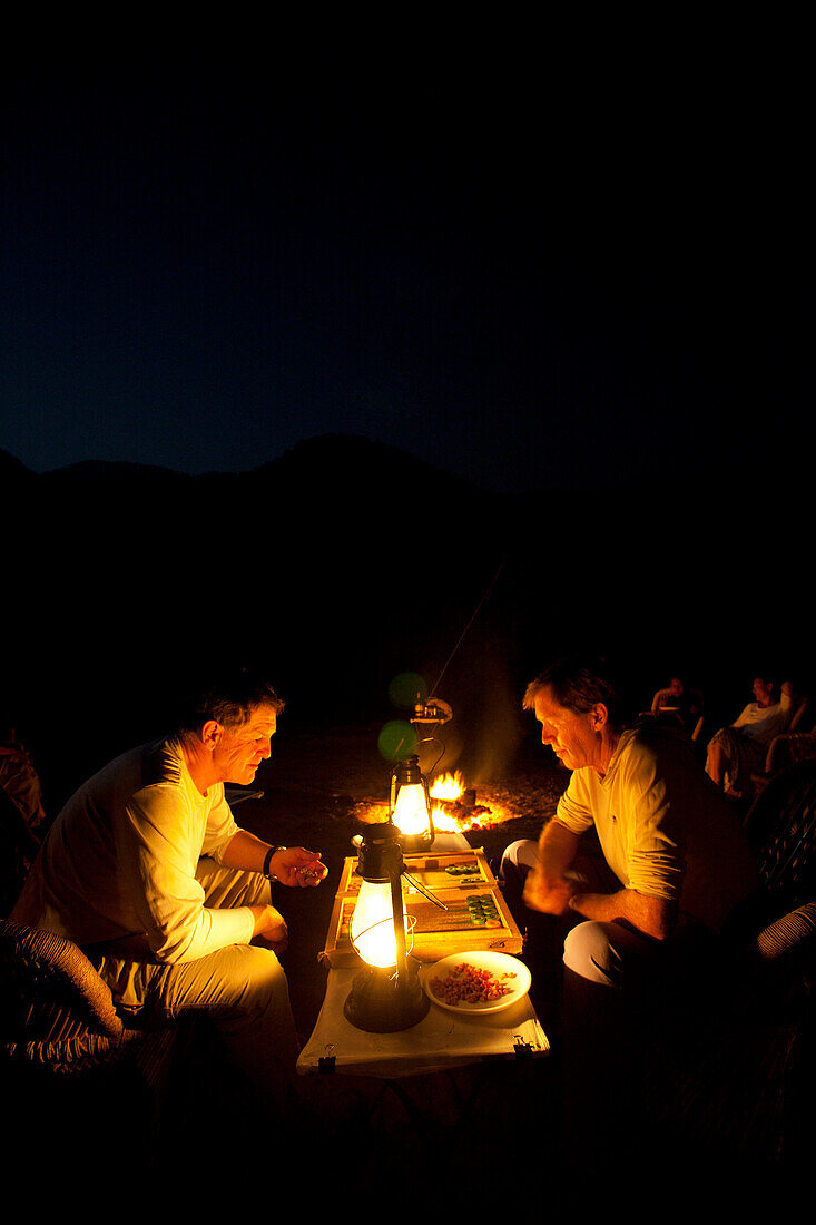 Two Men Playing Backgammon Outdoor by Lantern at Night, India