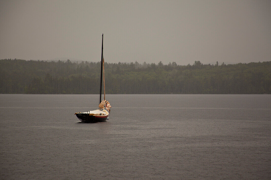 Sailboat Moored in Lake During Rain