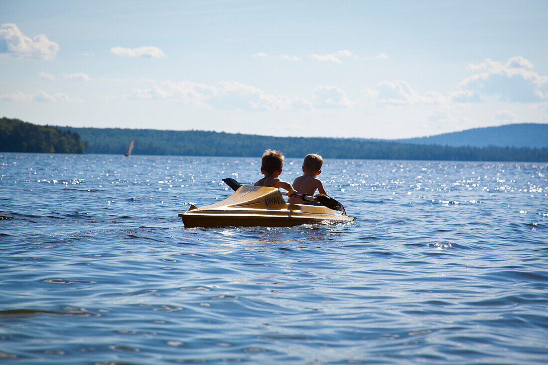 Two Young Boys Paddling Kayak, Rear View