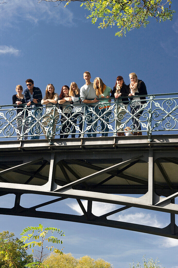 Group of young people standing on a bridge, Freiburg im Breisgau, Black Forest, Baden-Wurttemberg, Germany