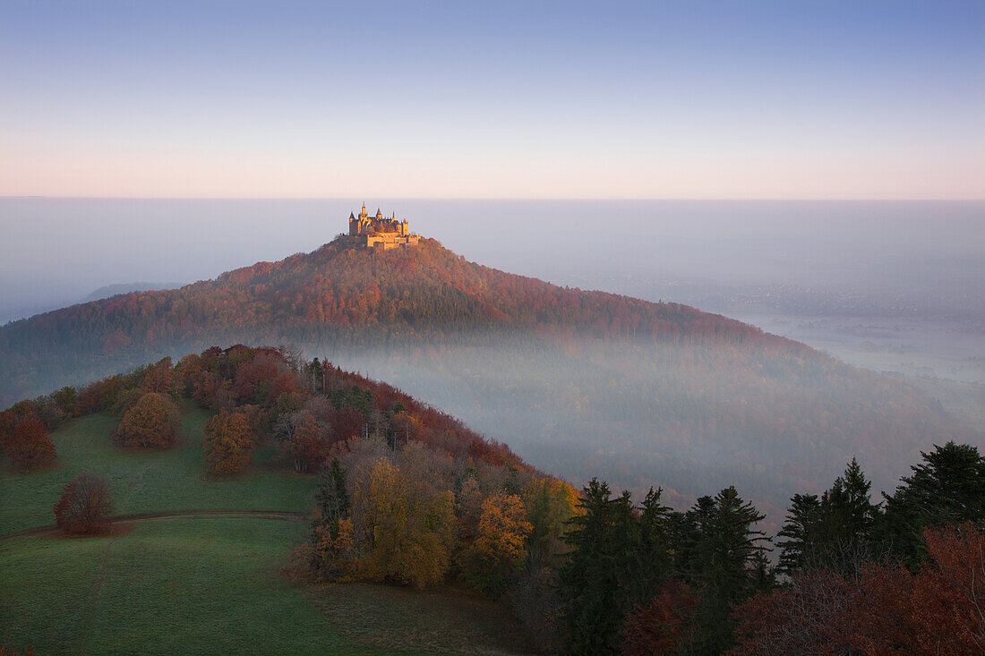 View to Hohenzollern castle in morning mist, near Hechingen, Swabian Alb, Baden-Wuerttemberg, Germany