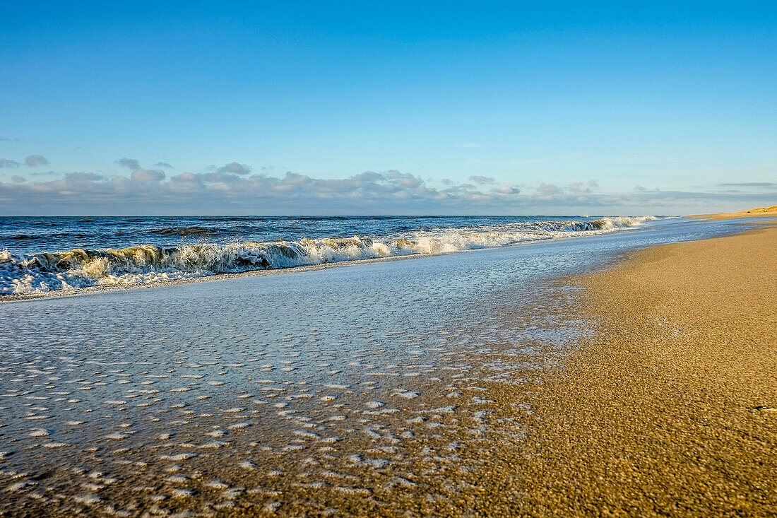 Water spray and waves at the beach of Rantum, island of sylt, north germany, germany
