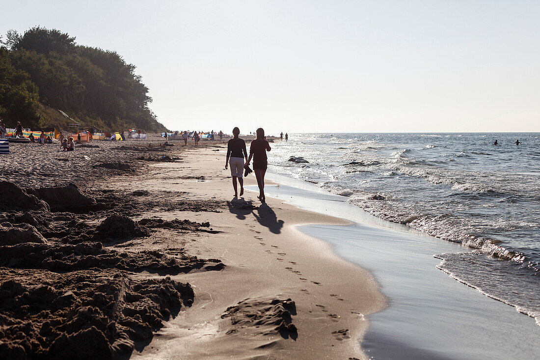 Two young women walking along the beach, Baltic Sea, Wittow Peninsula, Island of Ruegen, Mecklenburg West-Pomerania, Germany