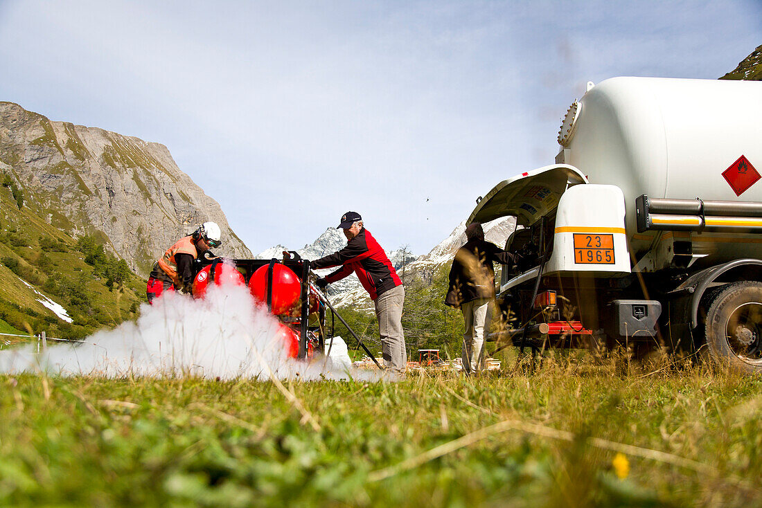 Men filling up gas tanks, Stuedl hut, Grossglockner, Tyrol, Austria