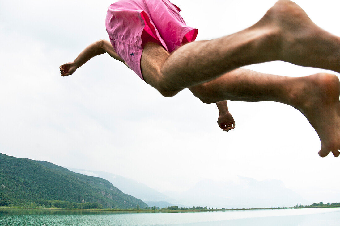 Man jumping into Lake Kaltern, Kaltern, Bozen, Trentino-Alto Adige/Suedtirol, Italy