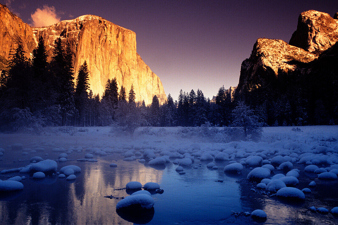 California, Yosemite National Park, Yosemite Valley, Sunset over El Capitan and snowy Merced River.
