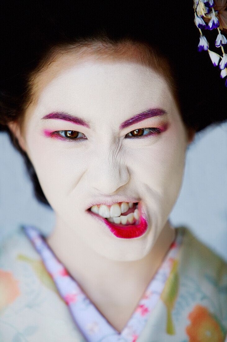 Portrait of Japanese Maiko making a funny face.