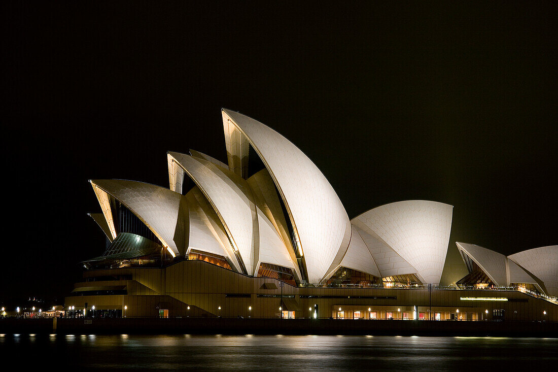 Australia, Sydney, A night scene looking across Sydney Harbor to the iconic Opera House.